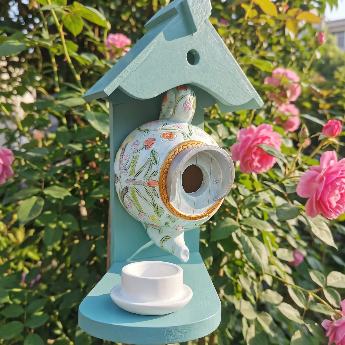 Teapot nest box among roses