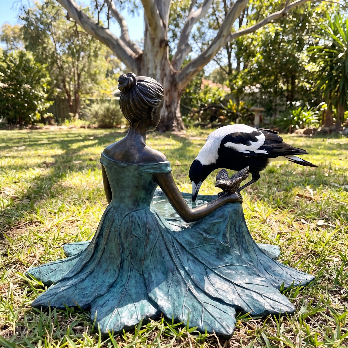 Back view of the bird bath with a magpie drinking