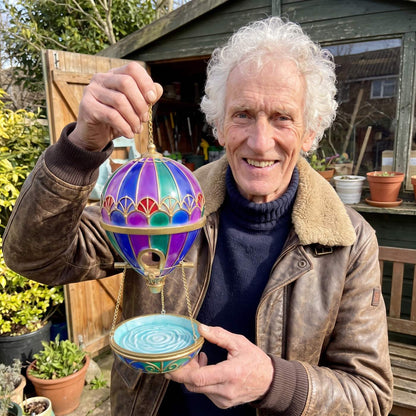 Ray Penhallow holding one of his balloon bird feeders