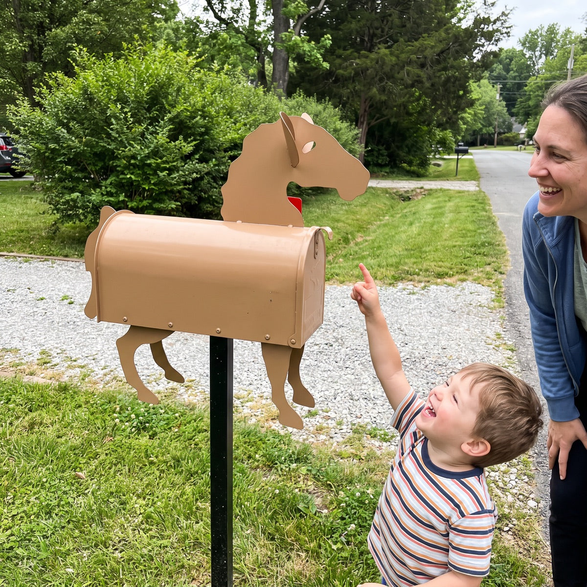 Child pointing at a horse mailbox