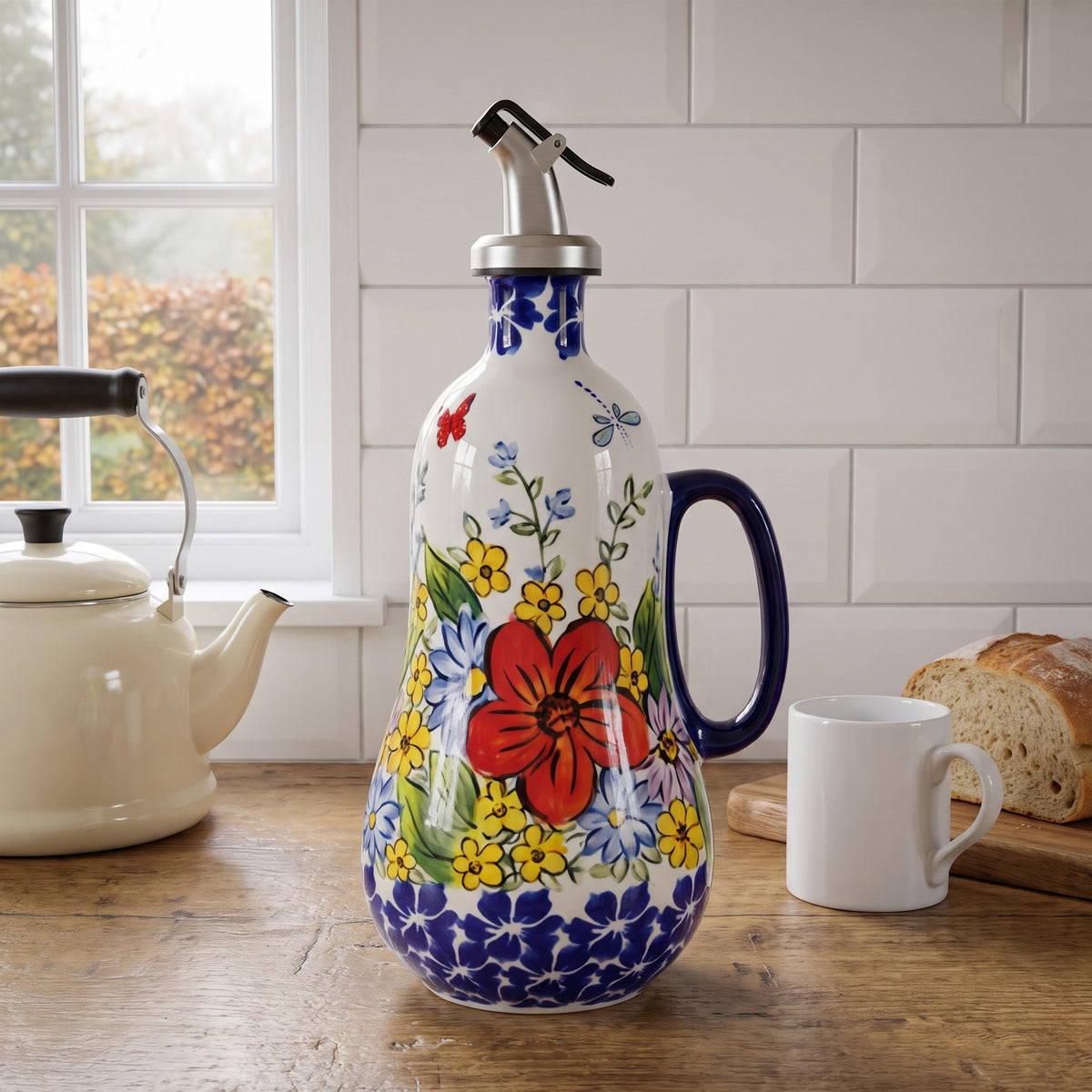 Avril's hand-painted olive oil dispenser in Red Poppy with a cobalt handle