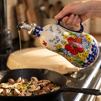 Pouring olive oil into a pan of mushrooms from the Red Poppy dispenser