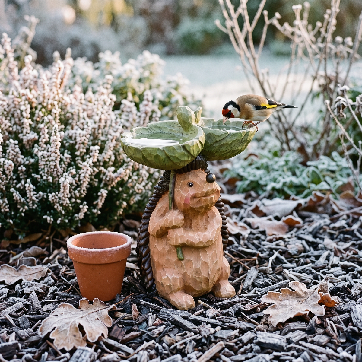 Hedgehog bird bath in a frosty garden