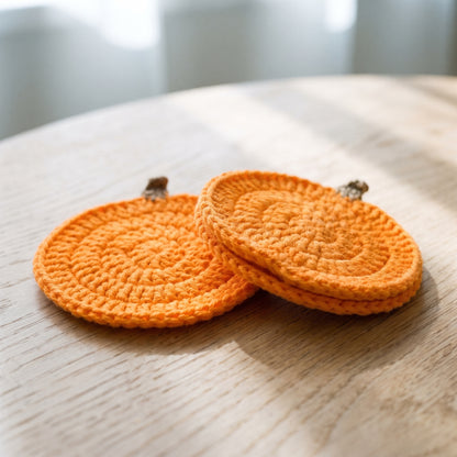 Edge detail of two coasters showing the double-thick crochet border and no glued backing