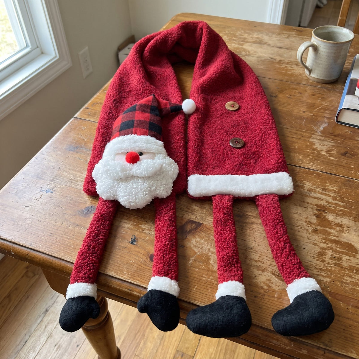 Santa scarf laid flat showing the padded head and four little boots