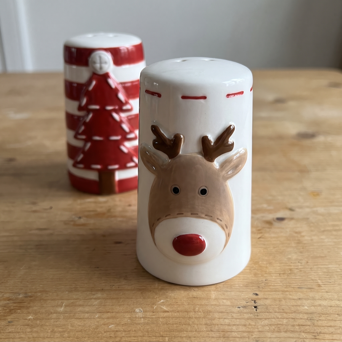 Close-up of the raised reindeer face on the white salt shaker
