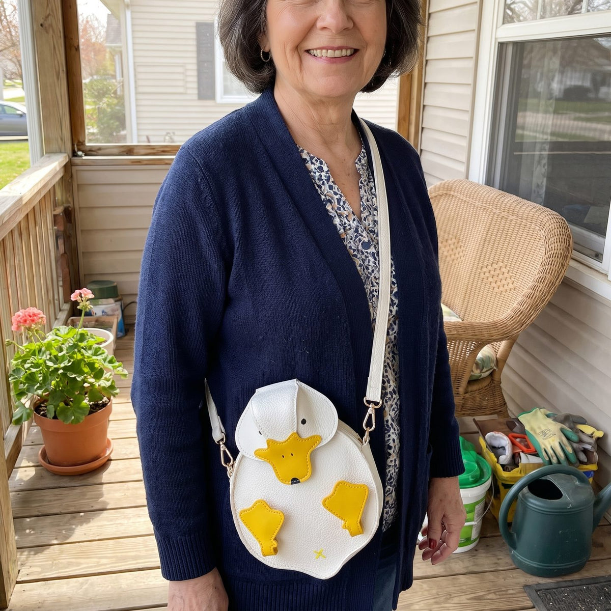 The duck bag worn crossbody on a sunny porch