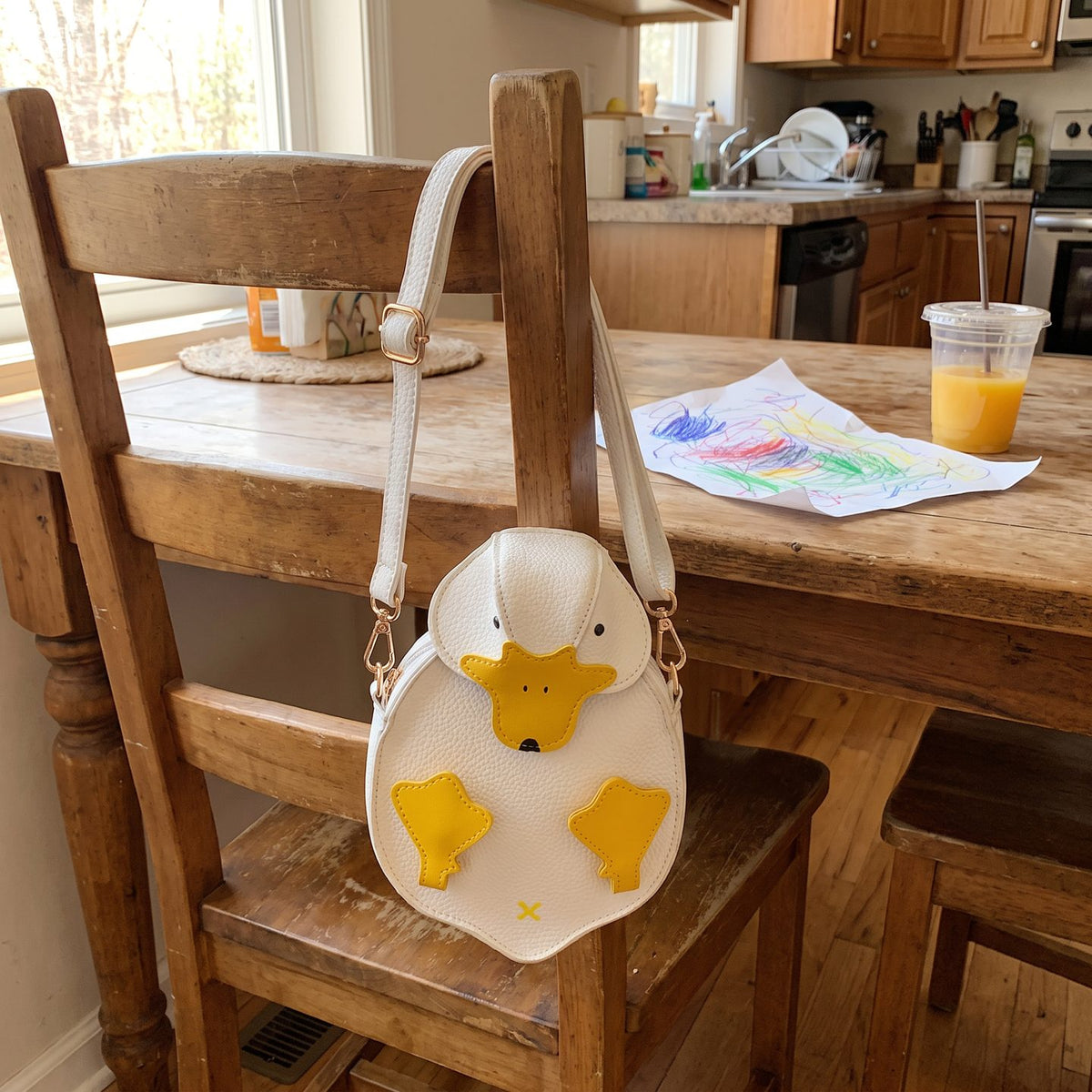 The duck bag hanging on a kitchen chair