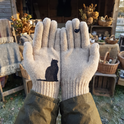 Oatmeal cat and robin gloves worn, palms up
