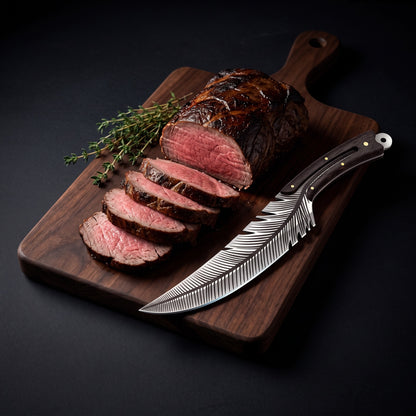 Feather knife beside a sliced roast beef tenderloin