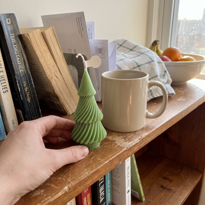 Little Tree candle on a bookshelf