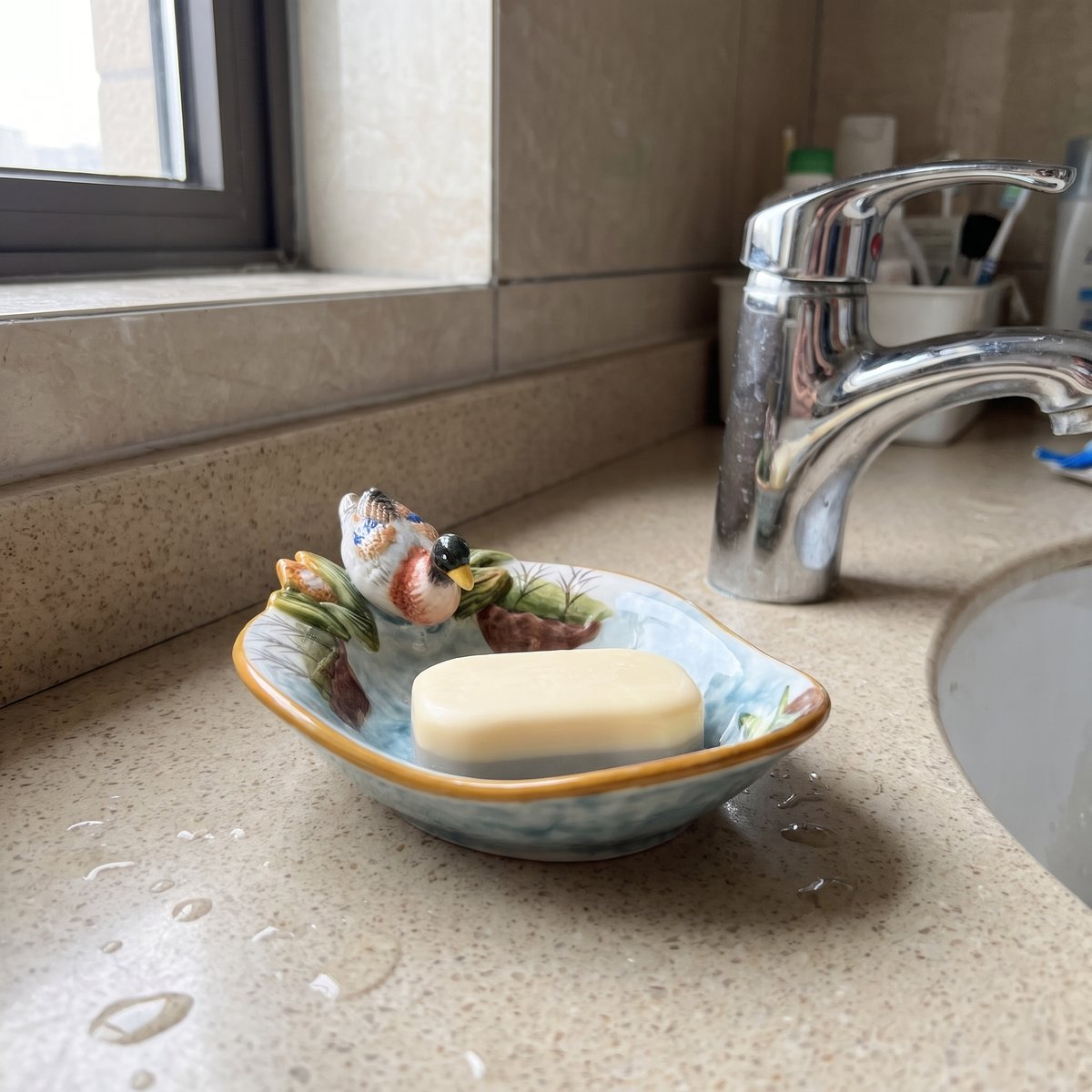 Mallard dish holding a bar of soap by the tap