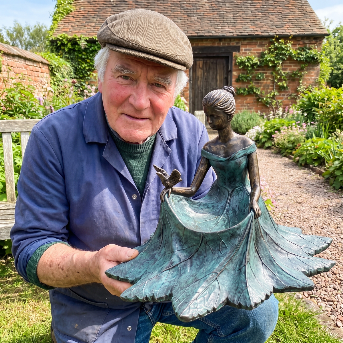 Geoff Hadley holding one of his last hand-cast bronze bird baths