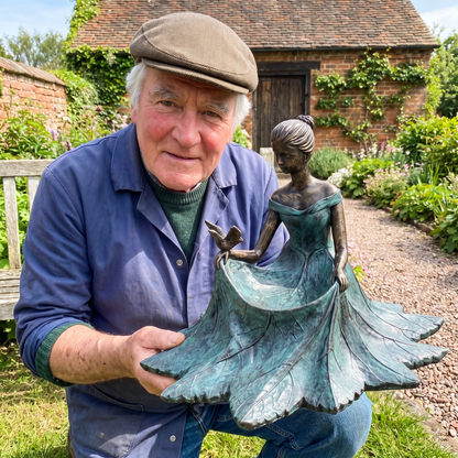 Geoff Hadley holding one of his last hand-cast bronze bird baths