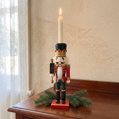 Gerhard's painted nutcracker soldier candle holder with a lit dinner candle on a jarrah sideboard