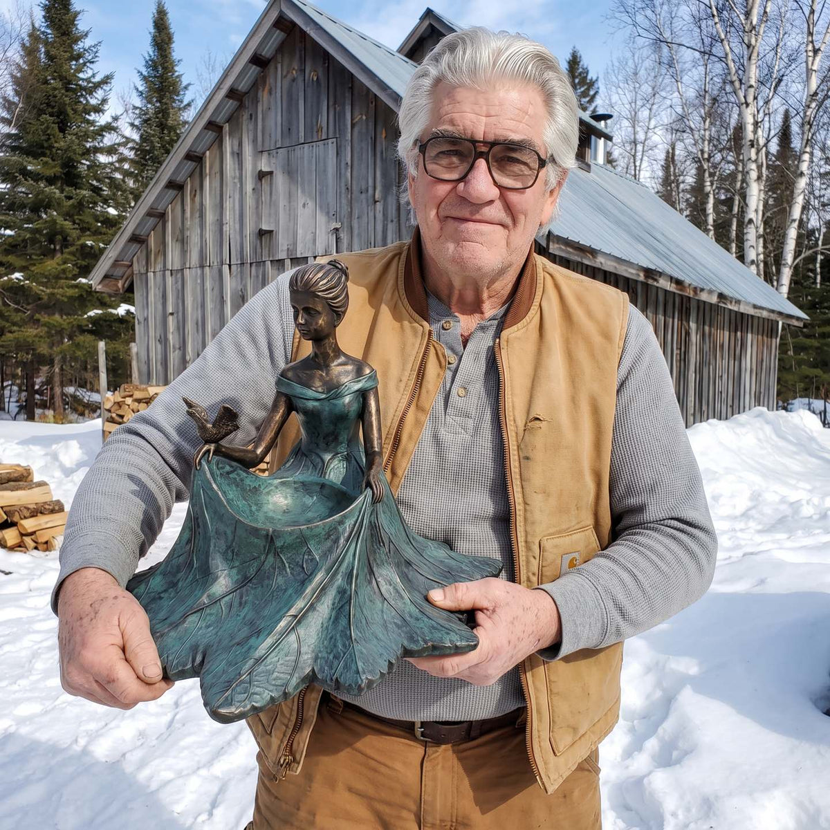 Gord Ferrier holding one of his last bronze bird baths