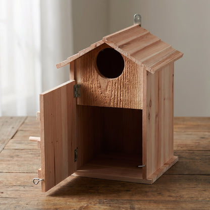 Owl house with its side cleaning door open, showing the deep interior