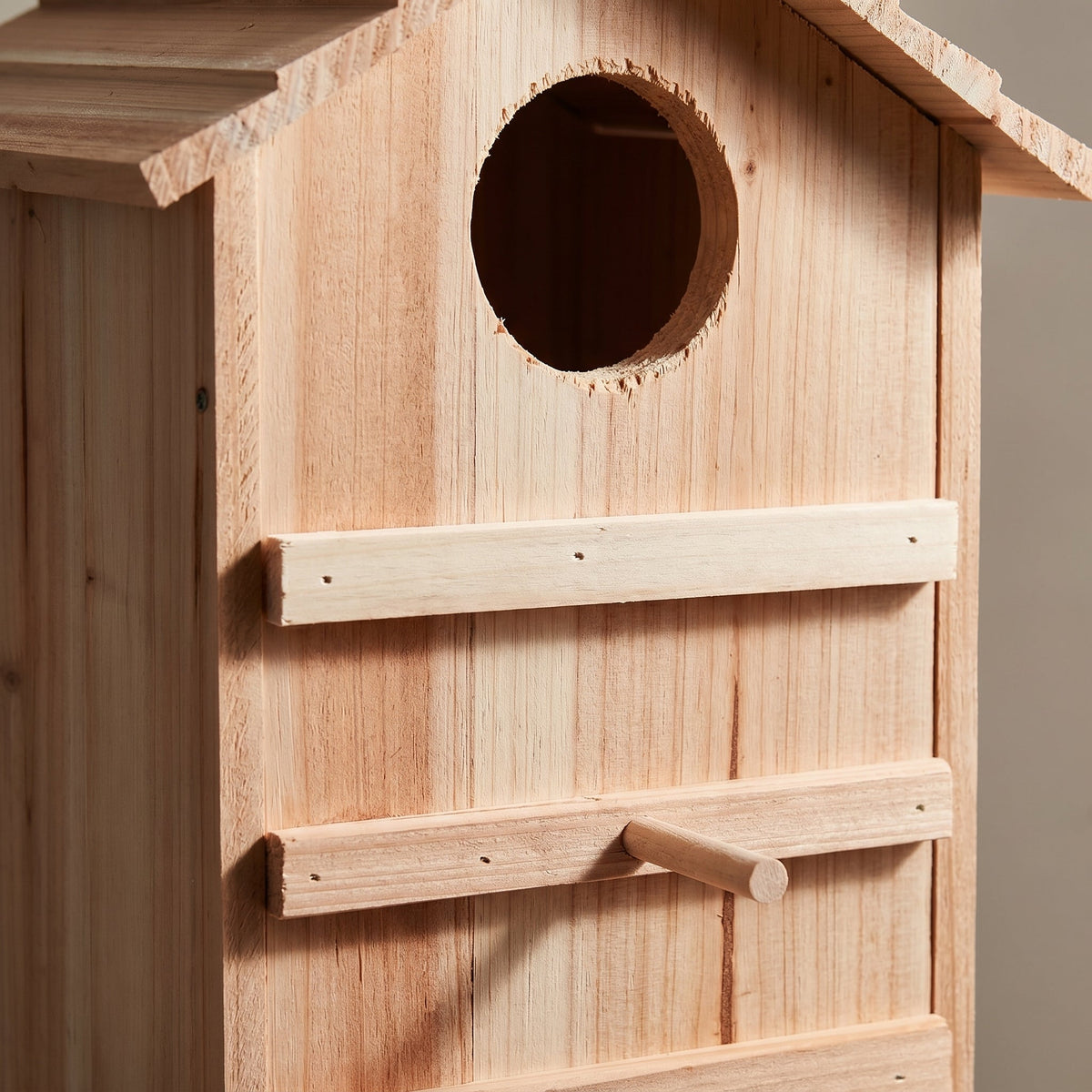 Close-up of the entrance hole and pine wood grain