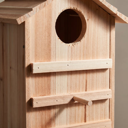 Close-up of the entrance hole and pine wood grain