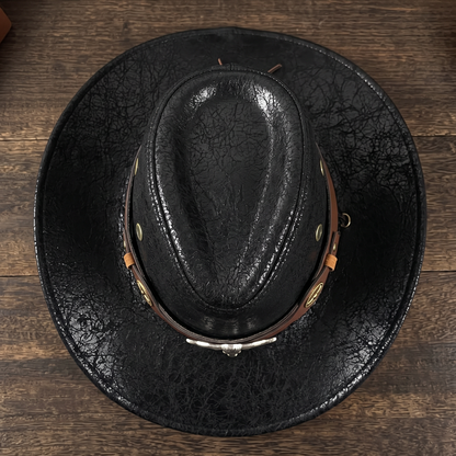 Top view of the black western hat showing crown crease and brass ventilation grommets