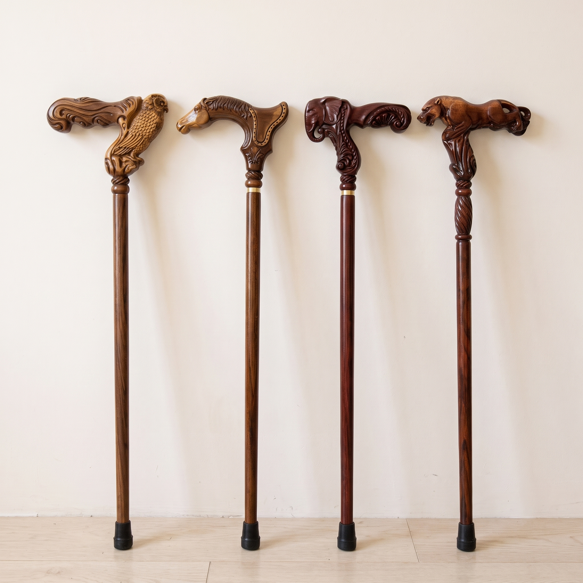 Four hand-carved wooden walking canes standing side by side: owl, horse, elephant and leopard grips