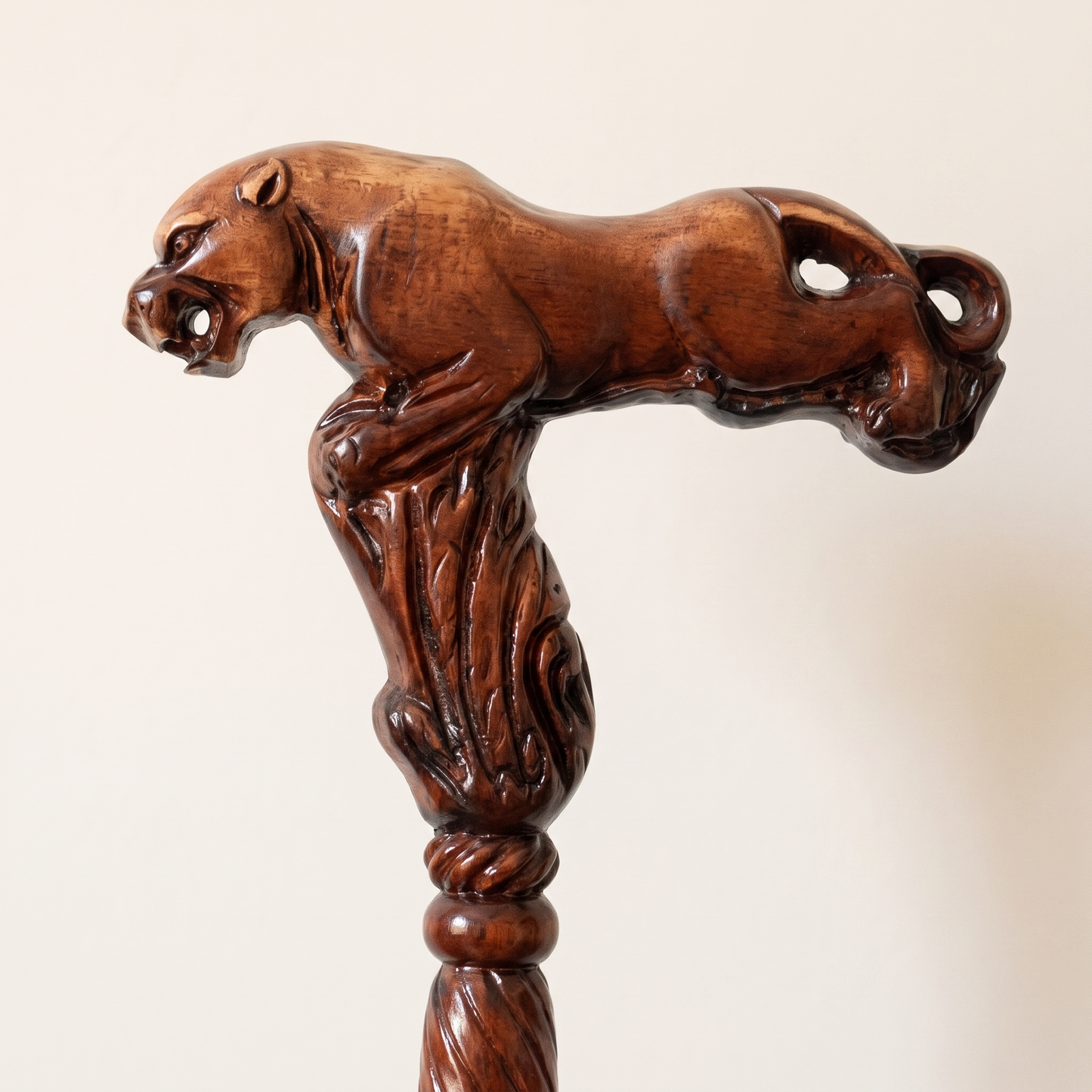 Close-up of the carved leopard grip, a crouching cat along the full length of the handle