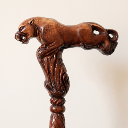 Close-up of the carved leopard grip, a crouching cat along the full length of the handle