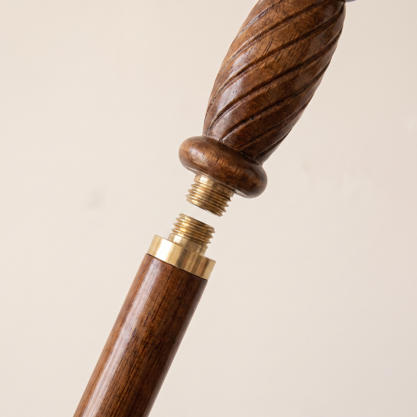 The brass collar unscrewed, showing the threaded joint that lets the cane come apart for travel