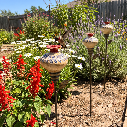 Three feeders in a cottage garden border