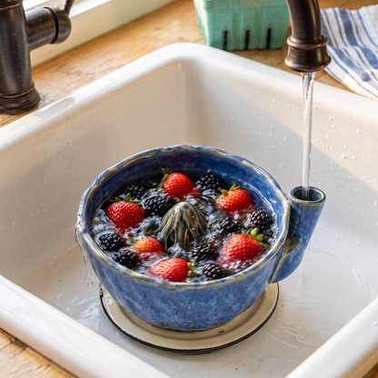Deep Cobalt berry bowl rinsing strawberries under the tap