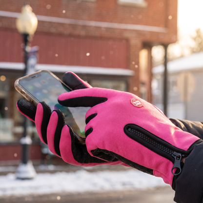 Rose Pink glove using a phone touchscreen at a snowy bus stop