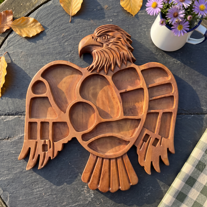 Hand-carved Eagle serving tray on a slate garden table