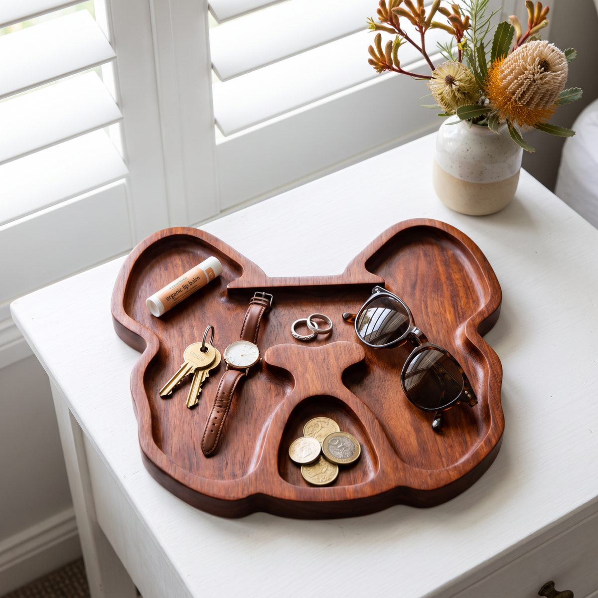 Bulldog serving tray used as a catch-all on a bedside table