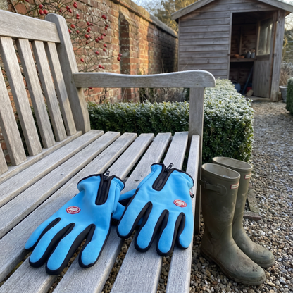 Sky Blue winter gloves on a frosty garden bench with wellies