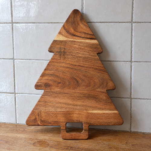 Arlis's Christmas tree cutting board in acacia standing on a kitchen counter