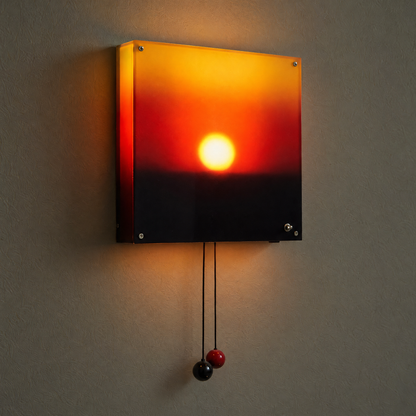 Side view of the sunset lamp showing the glowing acrylic case and the two pull cords
