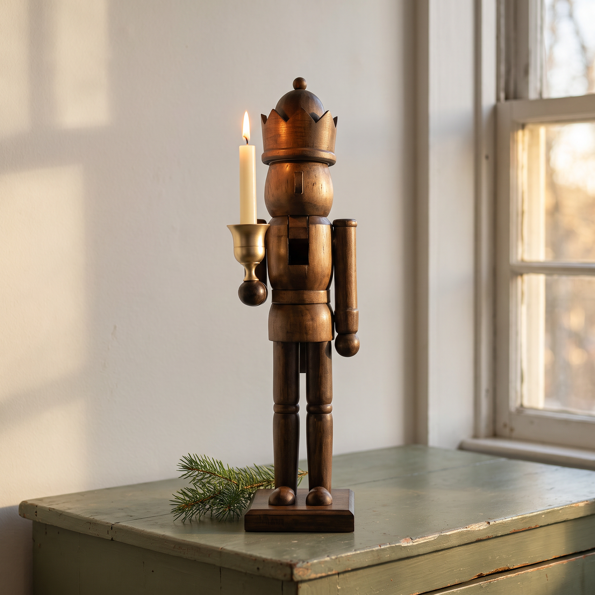 Norbert's natural pine nutcracker king with a lit taper in its brass cup on a farmhouse sideboard