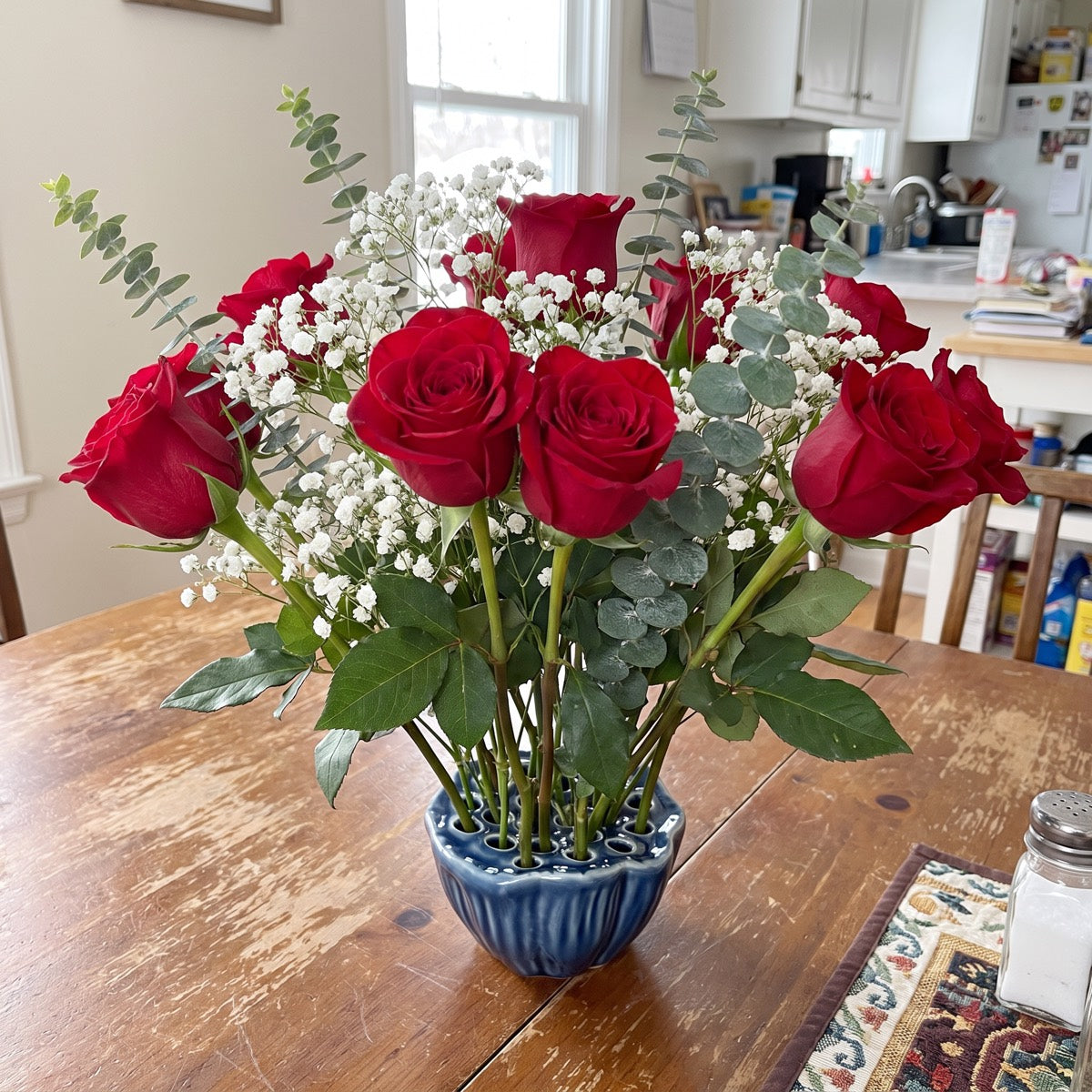 One red rose standing upright in the River Dusk lotus pod vase