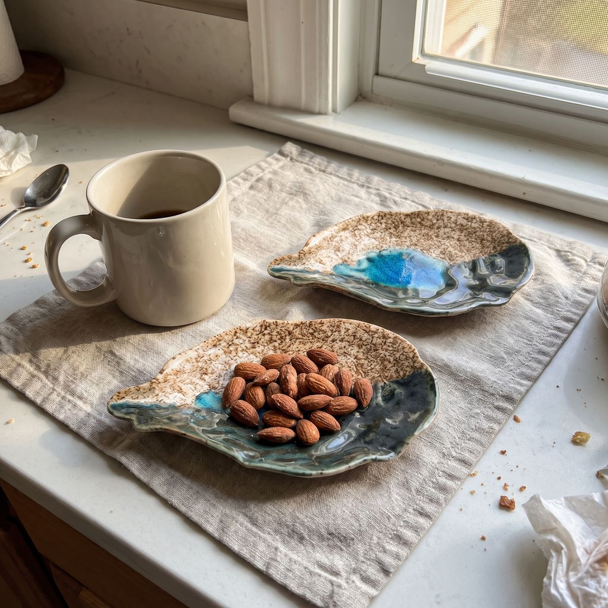 A pair of Cat Point Sand oyster plates, one with almonds