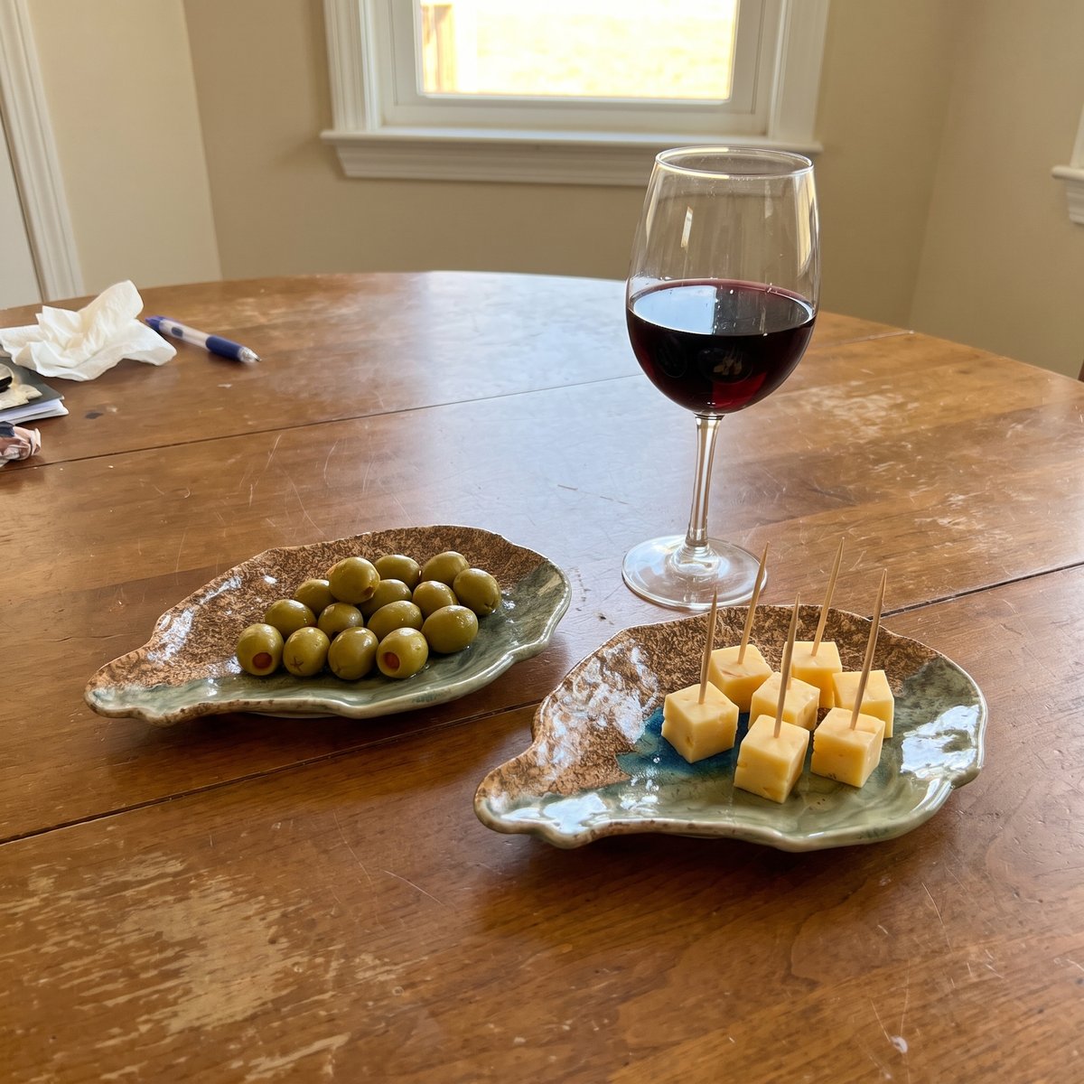 A pair of Dry Bar oyster plates with olives and cheese