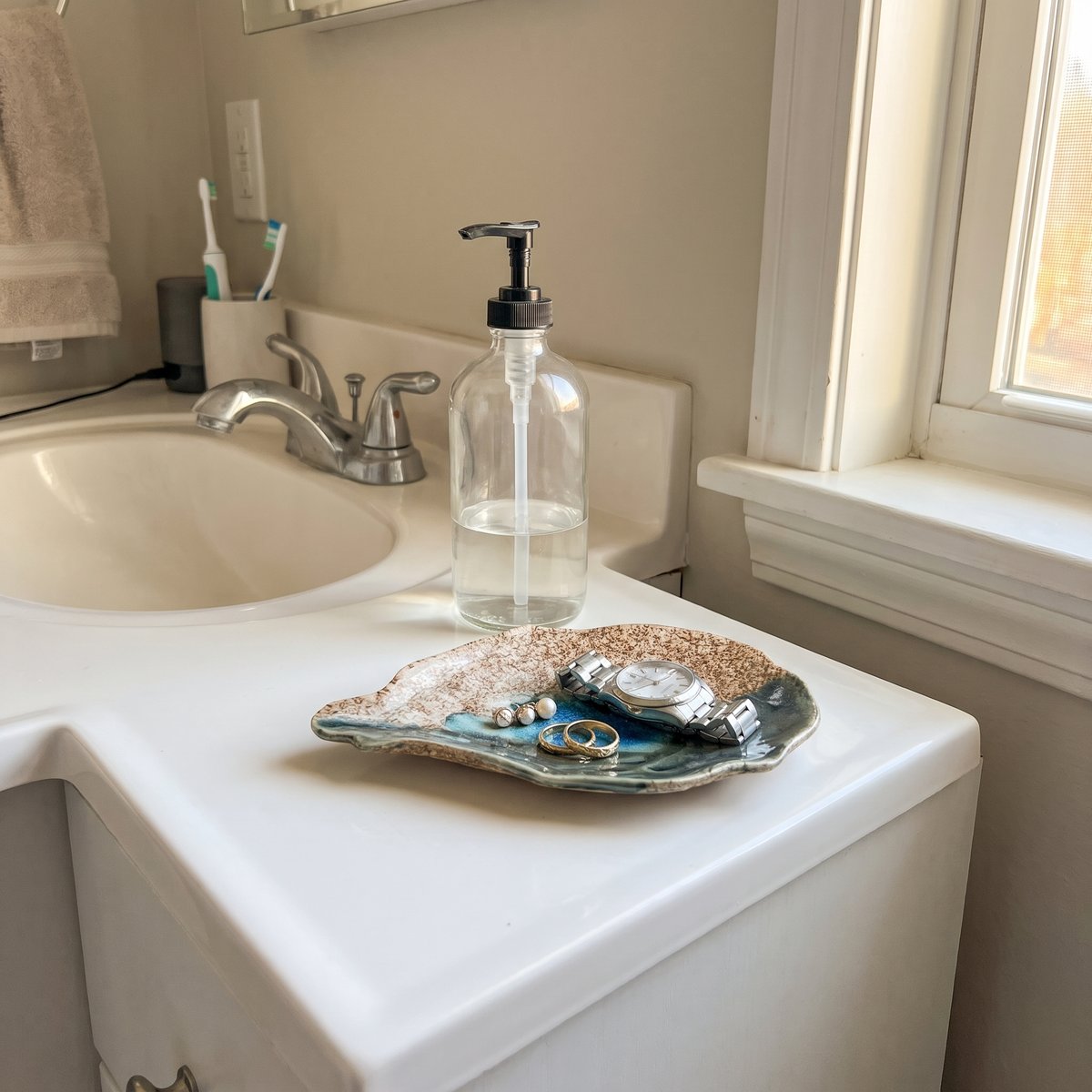 Cat Point Sand oyster plate holding rings on a bathroom vanity