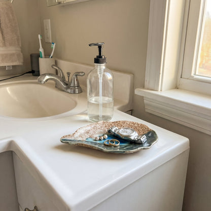 Cat Point Sand oyster plate holding rings on a bathroom vanity