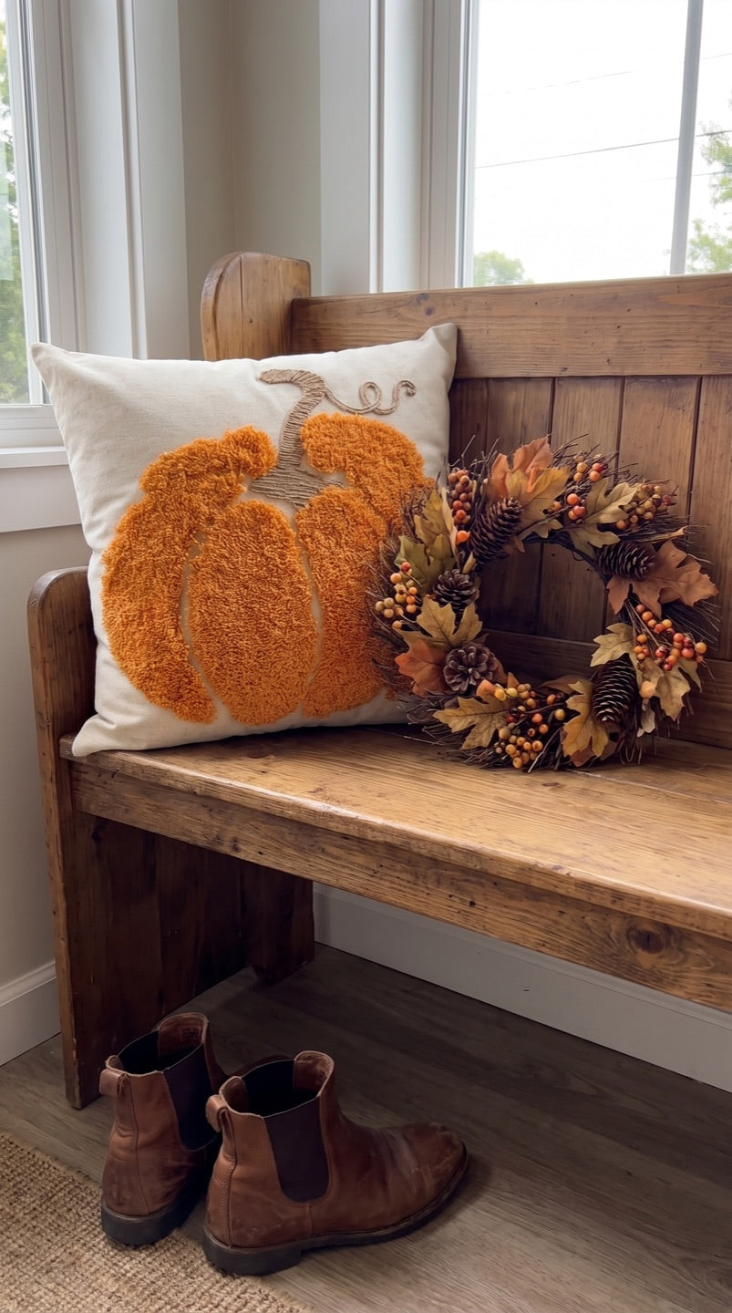 Customer photo of the pumpkin cushion on an entryway bench with a fall wreath