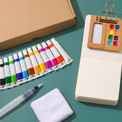 Everything in the box: walnut palette with brass clip, sketchbook, 12 paint tubes, water brush and wristband