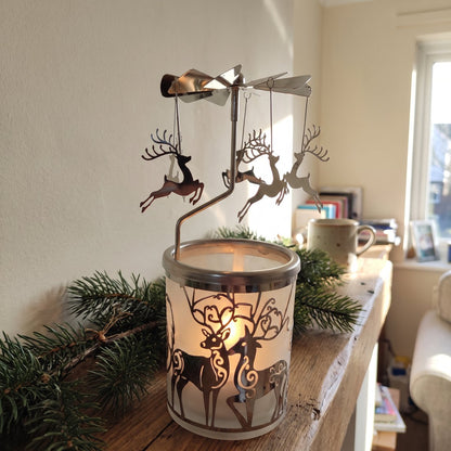 Margit's self-spinning candle carousel, Reindeer design in a glass cup