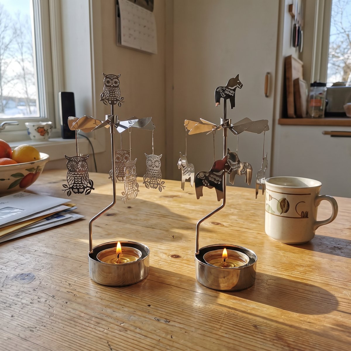 Owl and Dala Horse candle carousels side by side