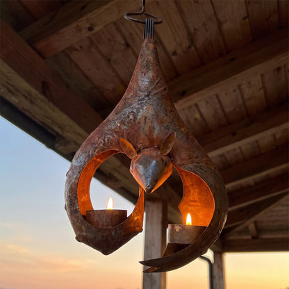 Seen from below: both tea lights glowing inside the iron bat lantern
