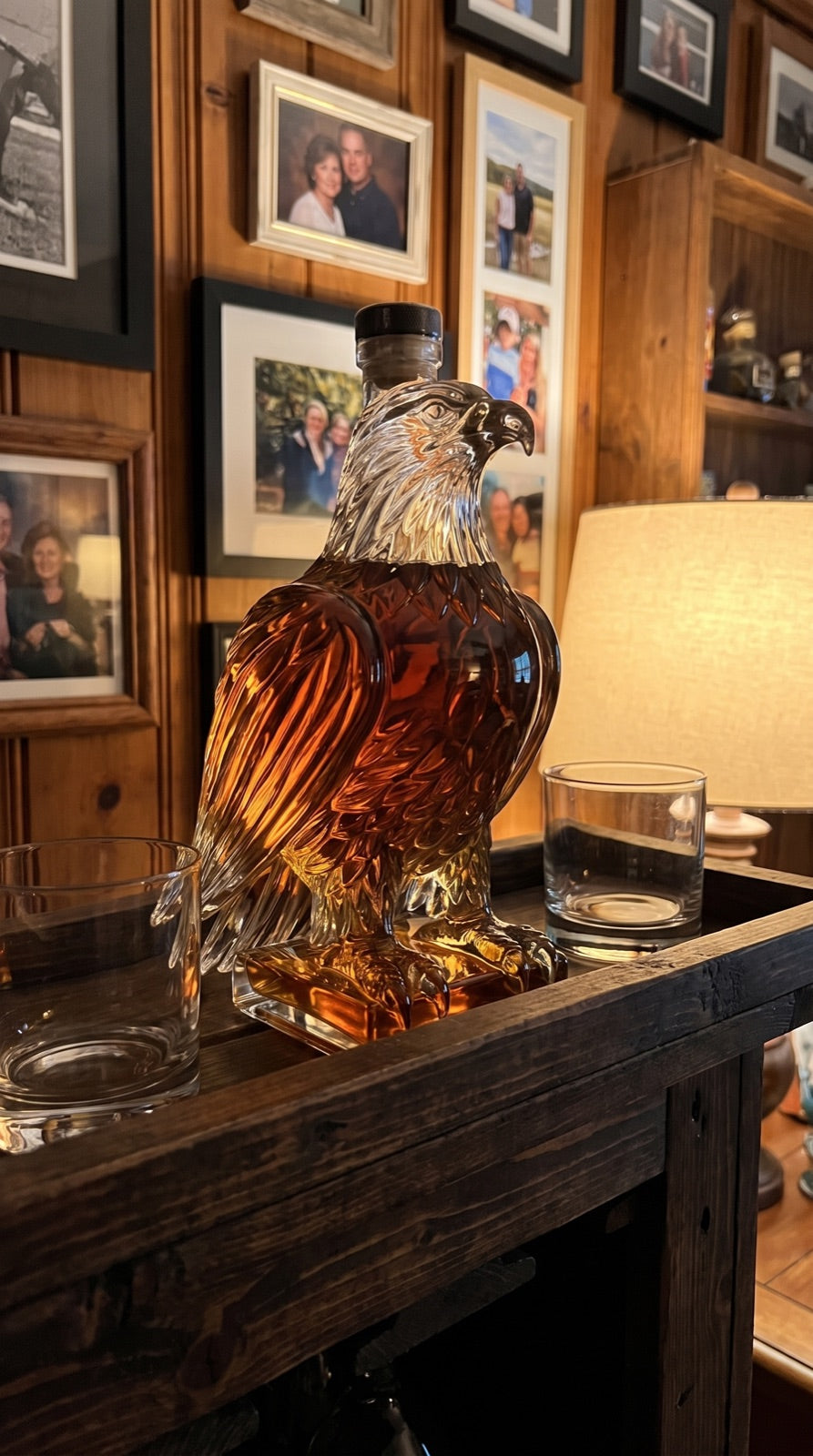 Eagle decanter on a bar sideboard among family photographs