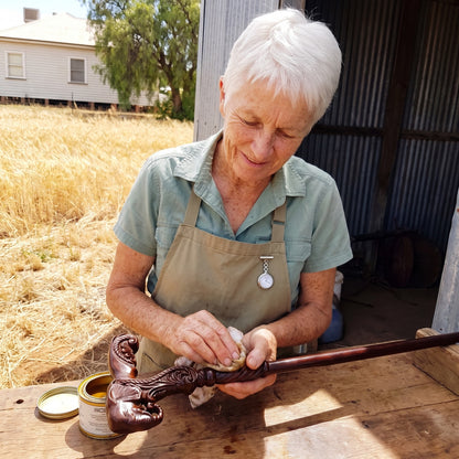 Margaret Doyle rubbing oil into a carved elephant-head grip